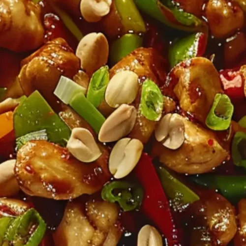 Plate of Panda Express–style Kung Pao Chicken with peppers and peanuts.