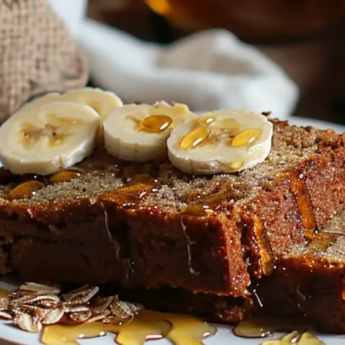 Banana bread slices without baking soda served with banana slices and honey.