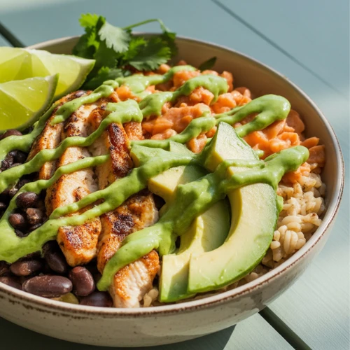 Meal prep grain bowl topped with green salsa verde.