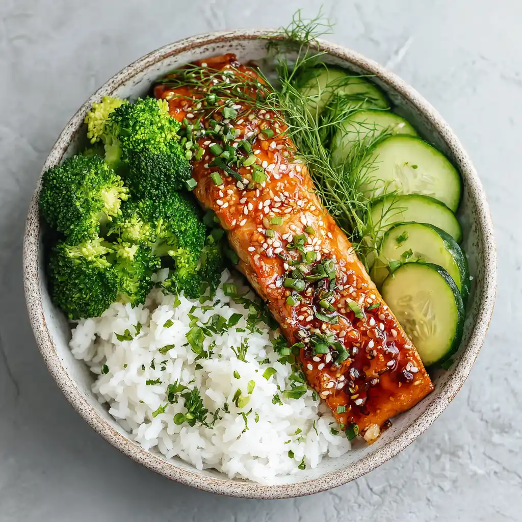 Salmon bowl with honey garlic glazed salmon, rice, broccoli, cucumber.