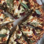 Thanksgiving pizza slice with cranberry drizzle and crispy onions